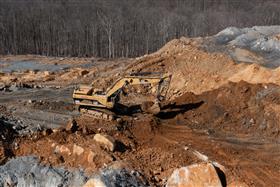Silver Hill Quarry: A Caterpillar 385B strips overburden to prepare for blasting.